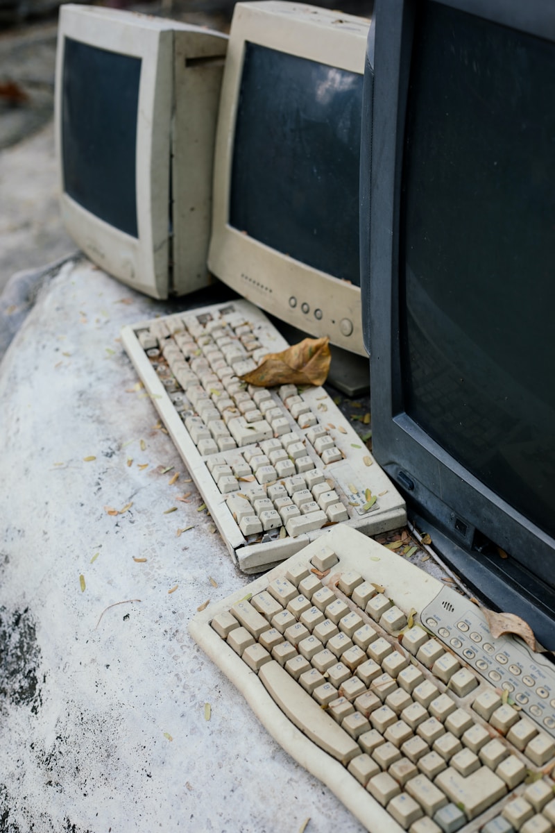 A couple of old computers sitting on top of a table